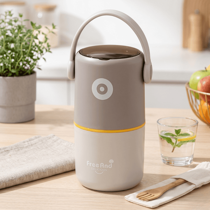 2 Layer Insulated Lunch Box with HandleStainless Steel Lunch BoxCrafty CuddleGray and yellow lunch box with a handle on a kitchen counter, featuring the brand &