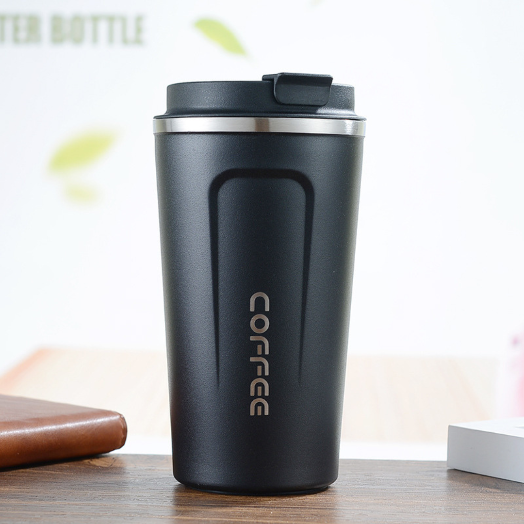 Black coffee tumbler with 'COFFEE' text on a wooden surface