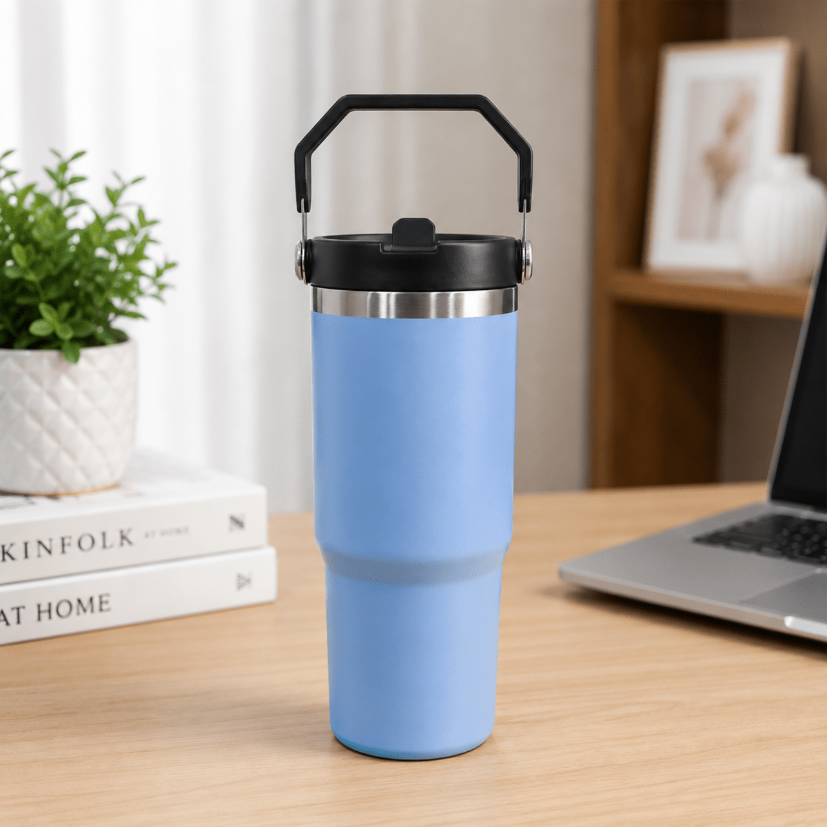 900ml Stainless Steel Insulated Tumbler with HandleInsulated Water BottleCrafty CuddleBlue insulated tumbler with black lid on a desk with a laptop and books in the background.Sky BlueStainlessSteelTumbler 900mlTumbler TravelMug StrawSipper InsulatedBottle LeakproofBottle BPAFree HydrationOnTheGo CupHolderFriendly TravelEssentialsStationeryAddict