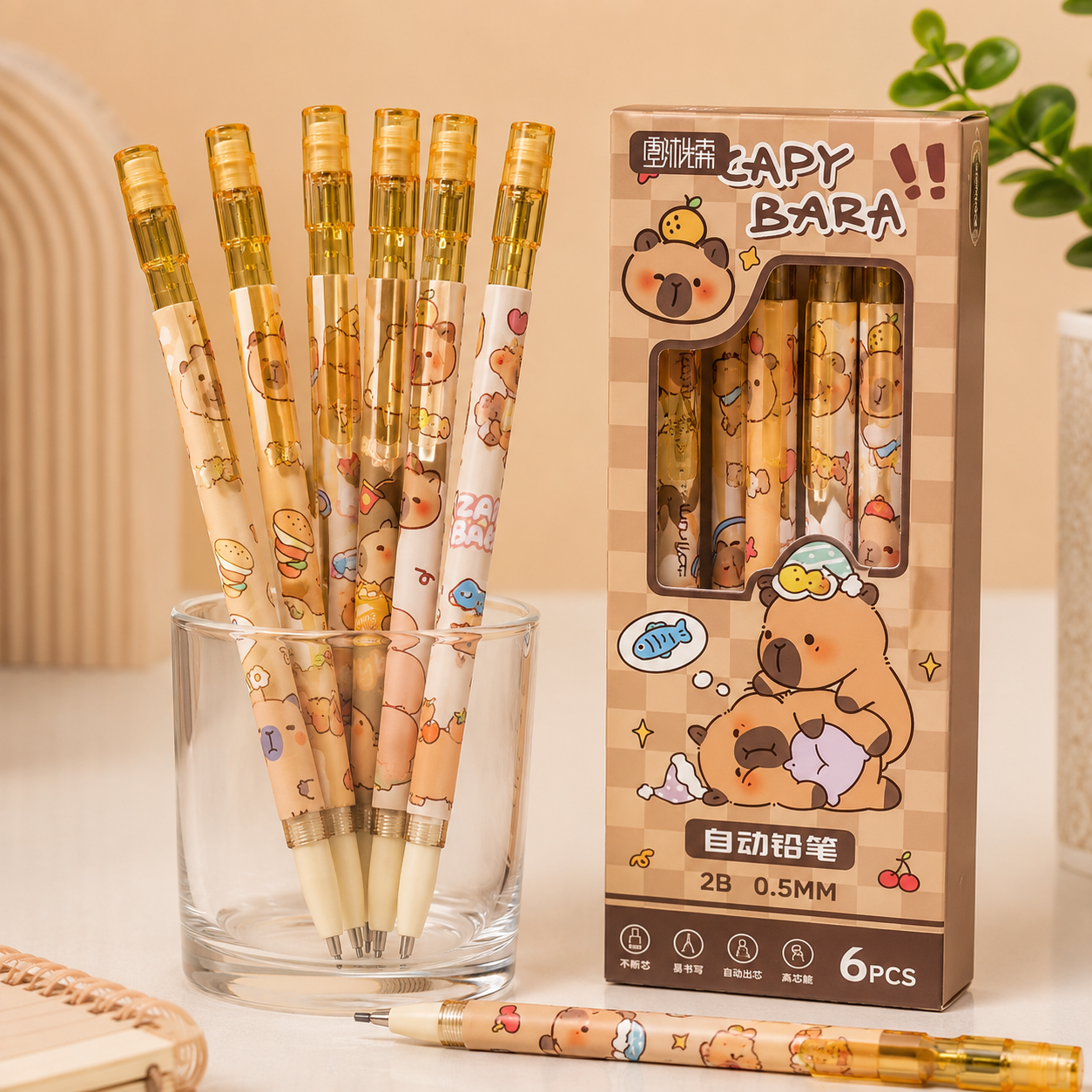 A set of cartoon-themed retractable mechanical pencils with a matching retail box, displayed on a light beige surface. The pencils and box feature a warm-toned bear illustration in shades of brown, beige, and yellow, with gold-toned caps.
