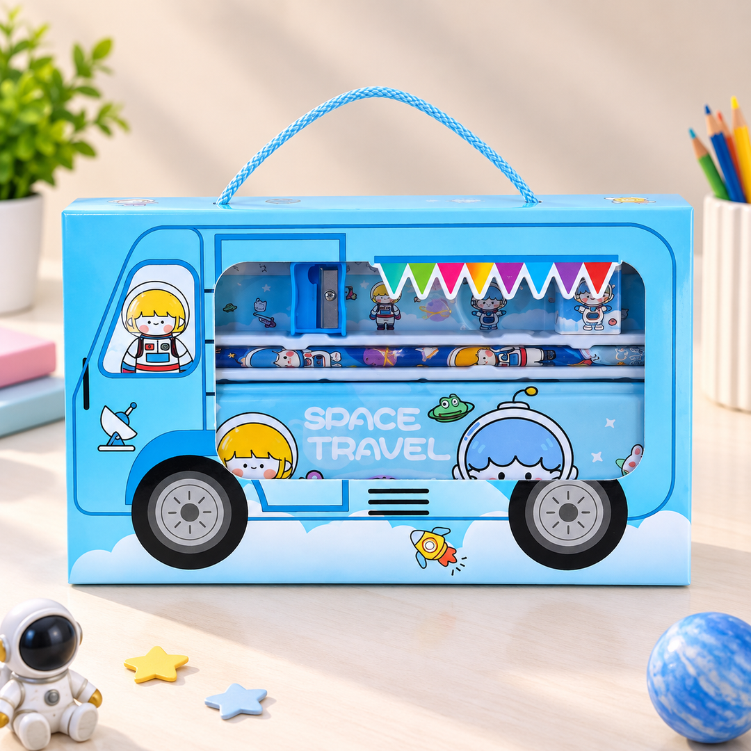 A blue toy storage box shaped like a space truck with a carrying handle, shown on a tabletop. The box has cartoon astronaut graphics, a window displaying colorful pens and small accessories, and the words &