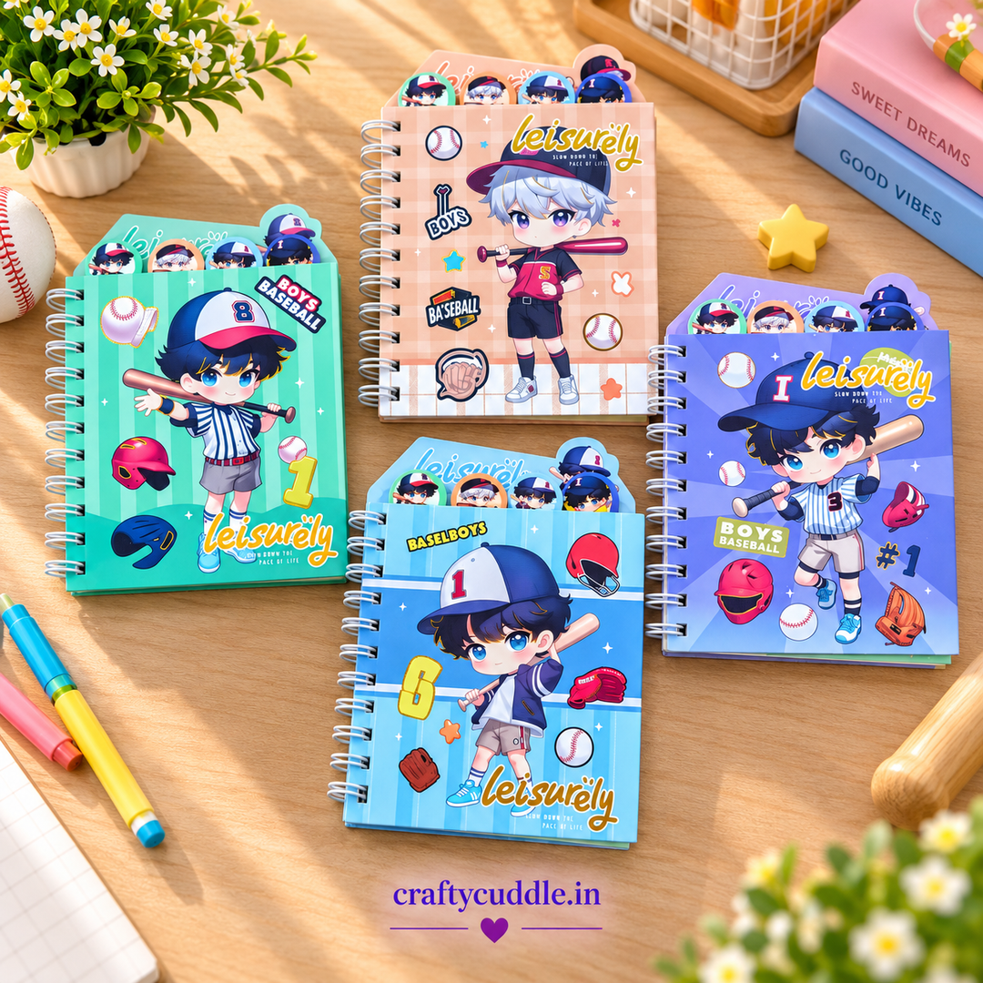 Four spiral-bound notebook toppers featuring cute baseball-themed cartoon characters, arranged on a wooden desk with decorative props including flowers, pens, and books.