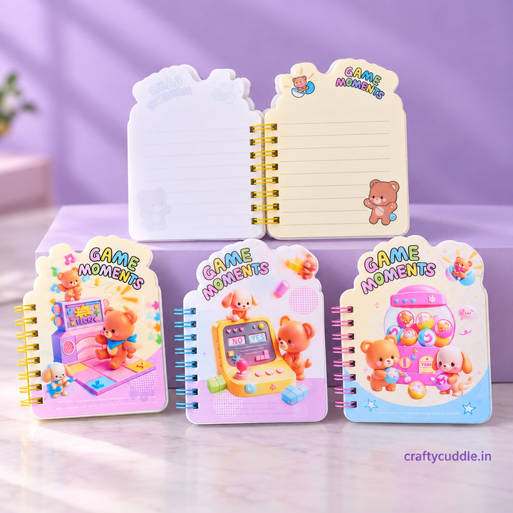 Three cute spiral-bound notepads with cartoon bear illustrations and colorful game-themed covers are displayed on a light purple surface. One notebook is open behind them, showing lined pages, and the other three are closed with different pastel game illustrations.
