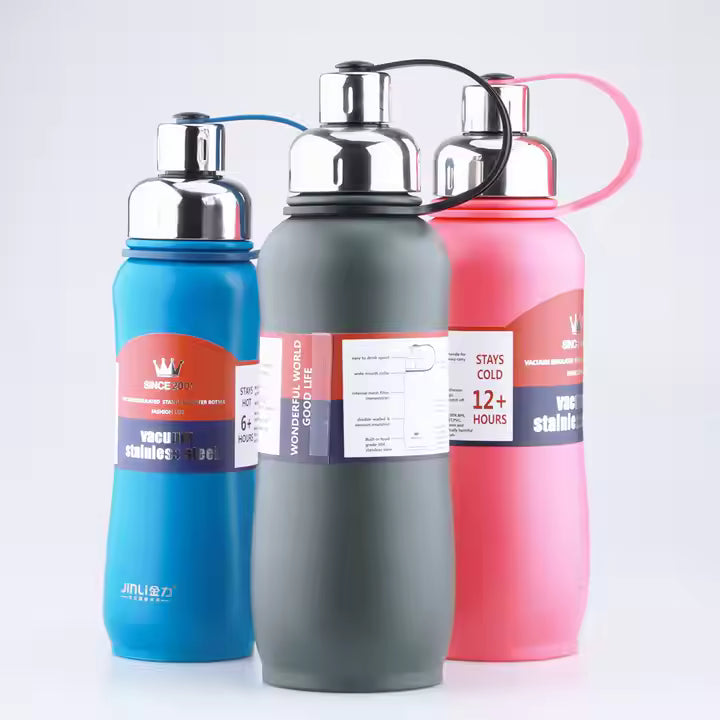 Three insulated water bottles in blue, gray, and pink on a white background