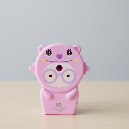Pink cartoon character pencil sharpener on a light beige surface with a light gray background