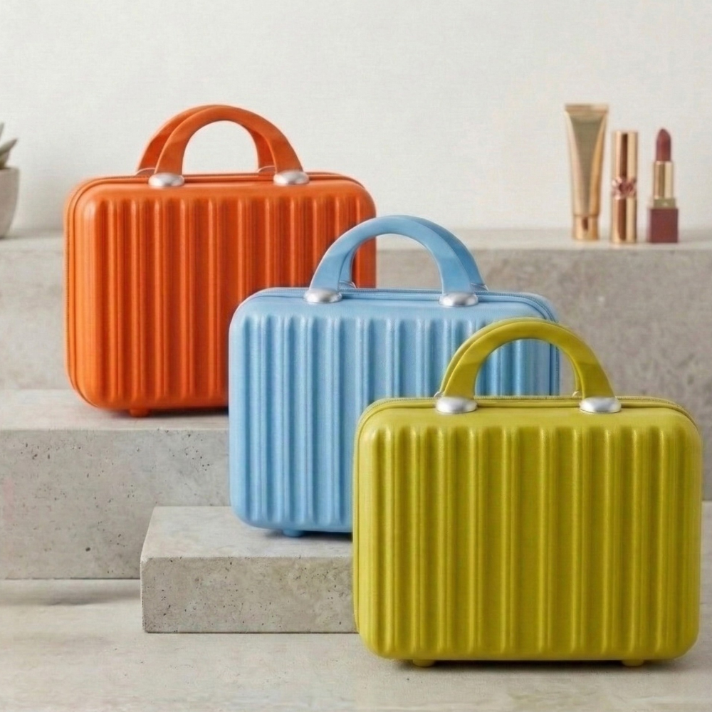 Three colorful makeup cases (orange, blue, yellow) on a neutral background
