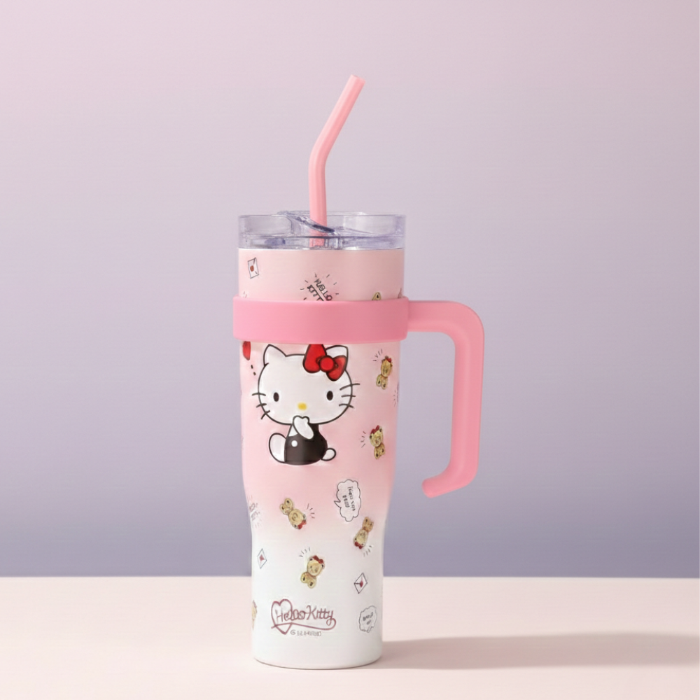 Pink tumbler with Hello Kitty design on a light purple background