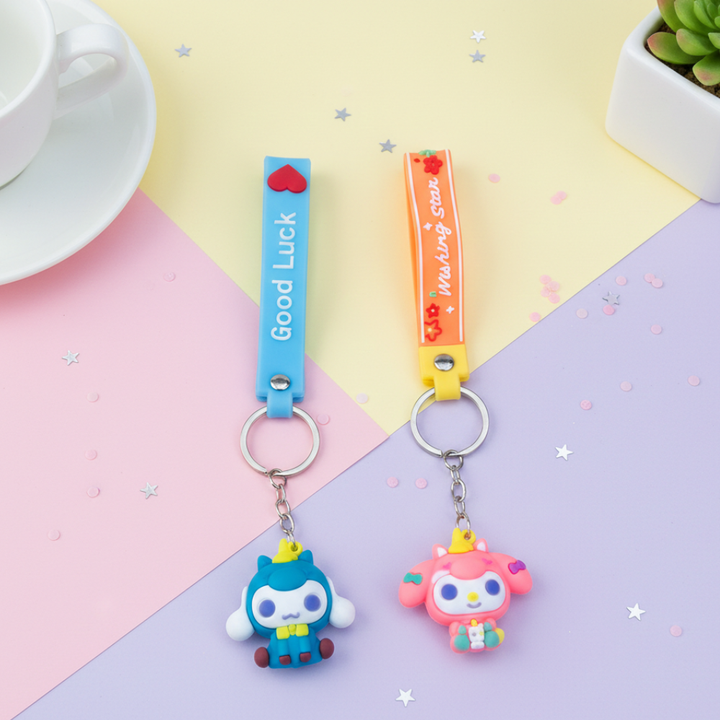 Two colorful keychains with cartoon characters on a pastel background