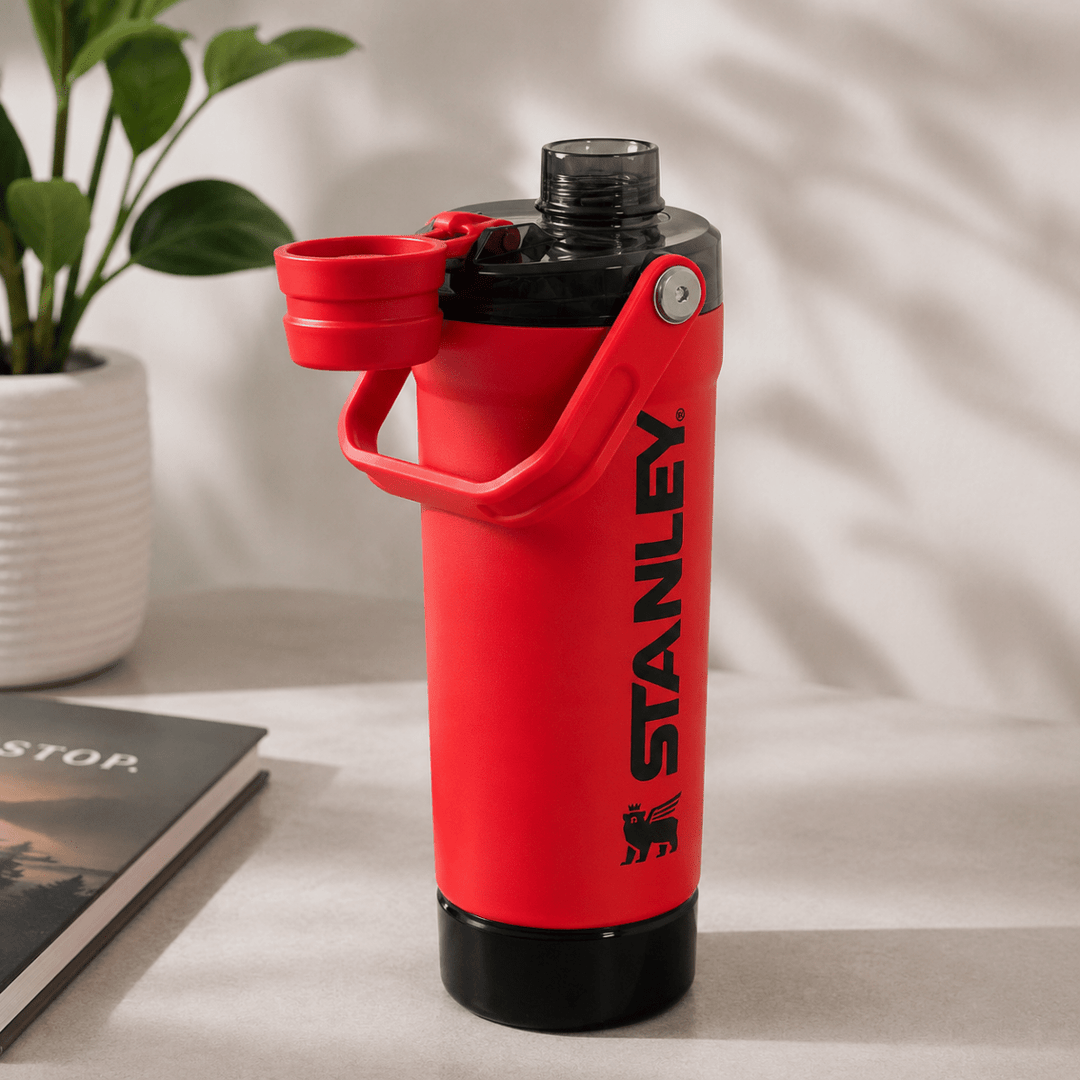 Activate Shaker BottleInsulated Water BottleCrafty CuddleA red Stanley insulated water bottle with a black base and a flip-up lid, shown on a tabletop with a plant and book in the background.RedShakerBottle ProteinShaker GymBottle FitnessEssentials WaterBottle WorkoutGear LeakproofBottle BPAFree SportsBottle Hydration