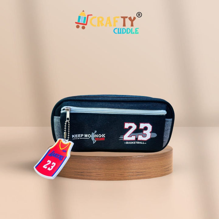 Black pencil case with number 23 and keychain on a beige background, featuring the brand &