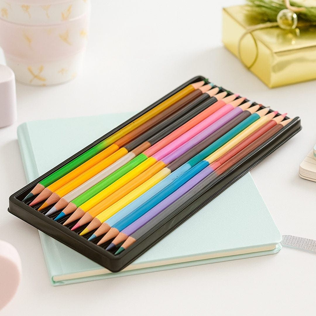 Bicolor Triangular Colour Pencils Pack of 12 (24 Shades)pencil colorsCRAFTY CUDDLESet of colored pencils in a case on a light blue notebook with a white backgroundcolouring pencils coloring supplies kids coloring tools art materials school art supplies colour pencil set color pencil pack student stationery