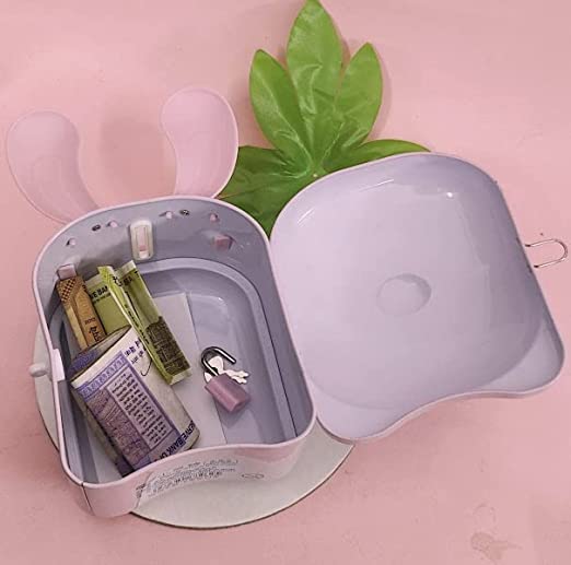 Small white coin bank on a pink background