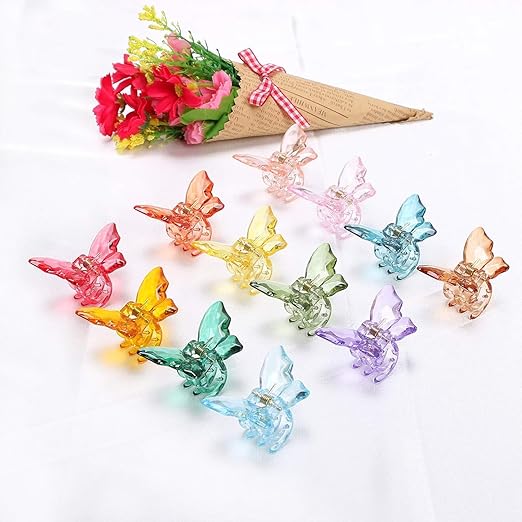 Colorful butterfly-shaped clips on a white background with flowers in the corner.