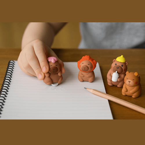 Capybara ErasersErasersCRAFTY CUDDLECartoon bear figurines erasers with colorful hats on a notebook with a pencil.1AnimalLoversCapybaraArt