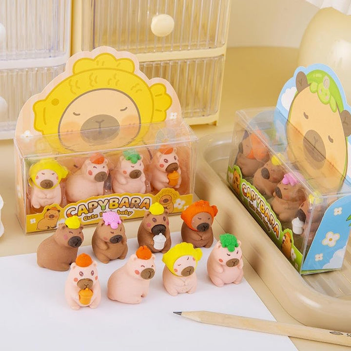 Capybara-themed erasers with packaging on a white surface
