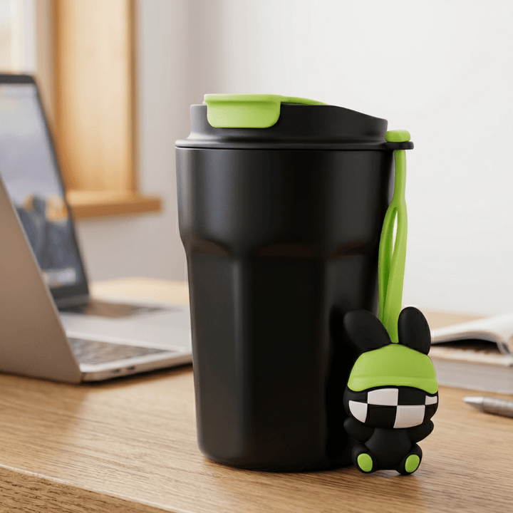 Cartoon Charm Insulated Coffee TumblerInsulated Coffee TumblerCrafty CuddleBlack travel mug with green accents on a desk next to a laptopBlackCuteTumbler AestheticCups TrendyDrinkware PastelVibes KawaiiStyle ReusableCup HydrationGoals CuteAccessories GiftIdeas HomeEssentials