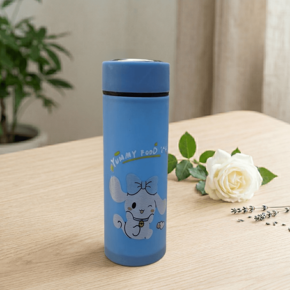 Cartoon Print Glass Water BottleCartoon Kids Water BottleCrafty CuddleBlue thermos bottle with a cartoon dog design on a wooden surface with a white rose and green leaves.Sky BlueWaterBottle CuteBottle KidsBottle CartoonBottle GlassBottle SchoolEssentials BackToSchool KawaiiStyle HydrationGoals CuteAccessories