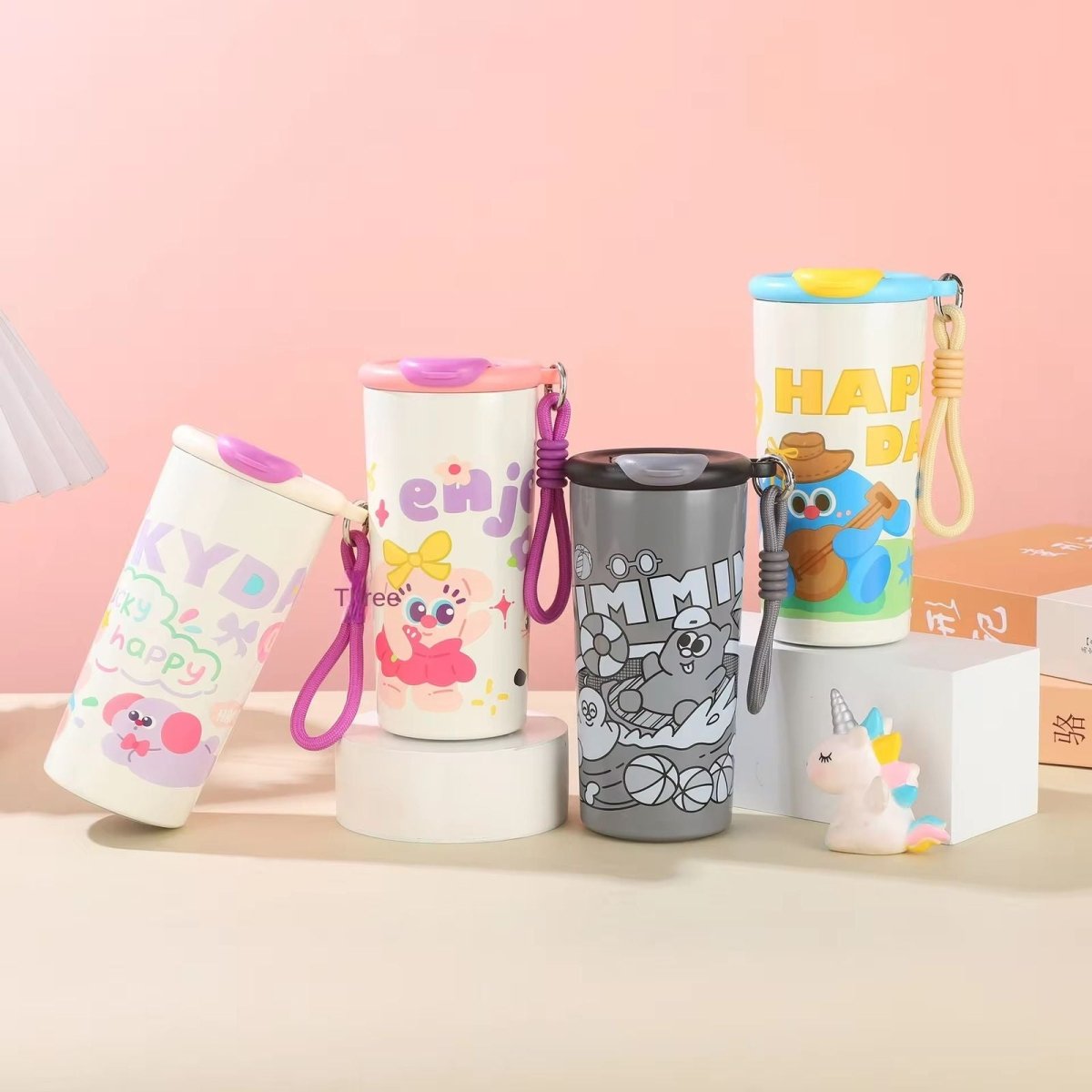 Cartoon Print Leakproof FlaskCartoon Kids Water BottleCrafty CuddleColorful water bottles with cartoon designs on a pink backgroundBlueKidsWaterBottle SchoolEssentials CartoonBottle StainlessSteelBottle LeakproofBottle KidsAccessories BackToSchool CuteStationery InsulatedBottle KidsHydration