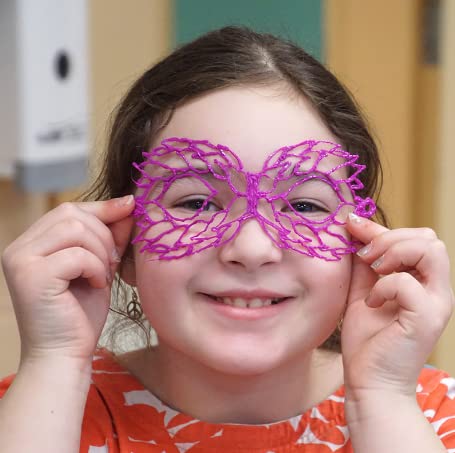 Child wearing a purple lace mask indoors