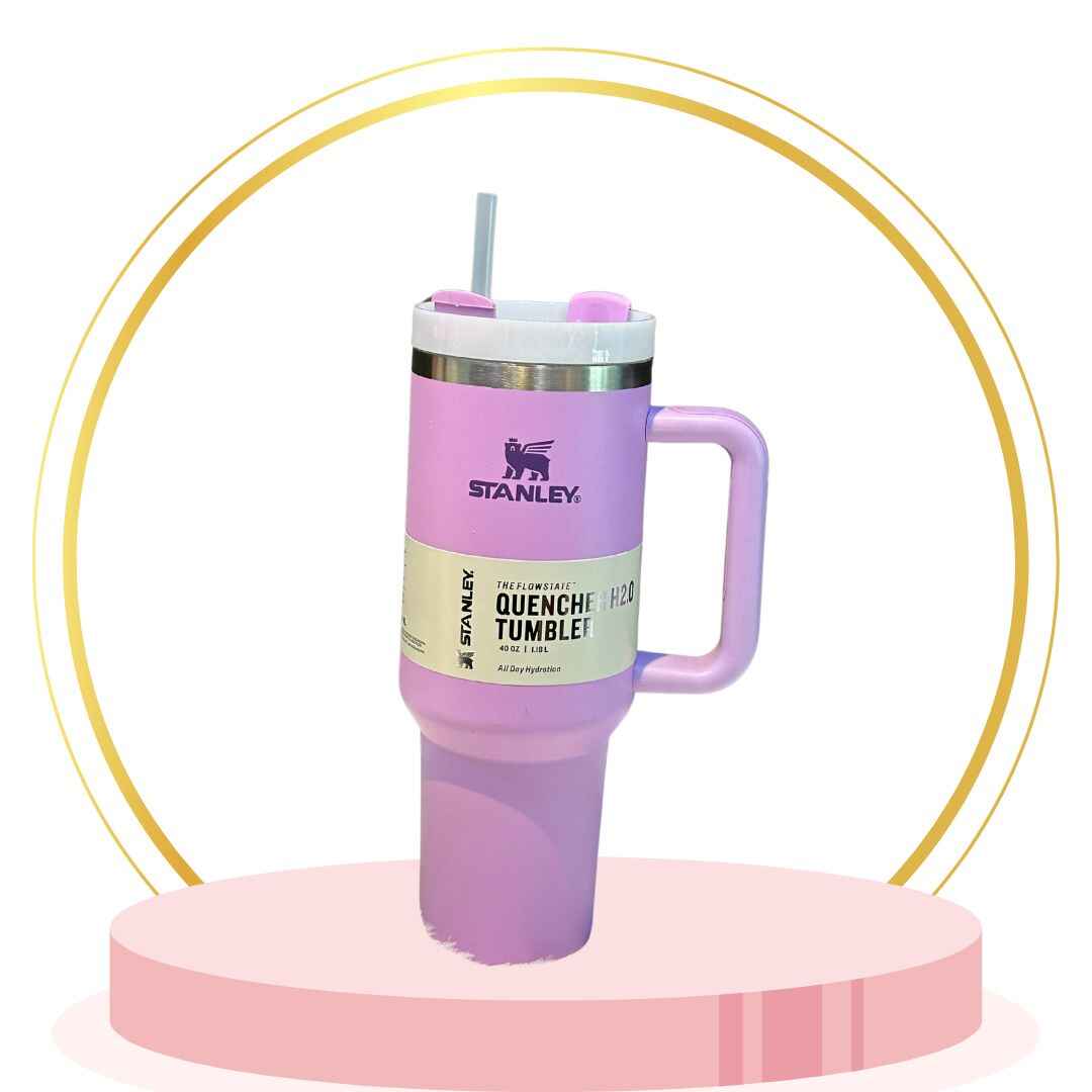 Pastel pink 20 oz insulated Stanley tumbler with straw and non-slip base keeps drinks hot or cold.