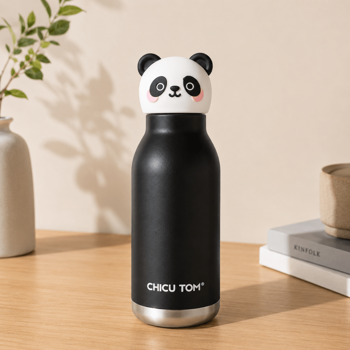 Cute Animal Water BottleCartoon Kids Water BottleCrafty CuddleA black insulated water bottle with a cute panda-shaped lid, standing on a wooden table. The bottle features the brand name 'CHICU TOM' in white text near the bottom.Bamboo PandaCuteWaterBottle KidsWaterBottle ThermosFlask InsulatedBottle StainlessSteelBottle BackToSchoolEssentials CuteStationery KidsLifestyle ReusableBottle ChicuTomStationeryAddict