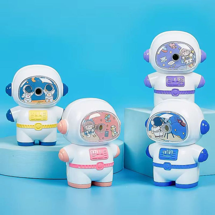 Cute Astronaut Manual Pencil SharpenerStationery > Erasers &amp; SharpenersCRAFTY CUDDLEFour colorful astronaut - themed sharpeners on a blue backgroundBlueAstronautStationery SpaceTheme CuteStationery KidsStationery PencilSharpener CartoonStationery BackToSchool SchoolSupplies StudyEssentials ReturnGiftIdeas