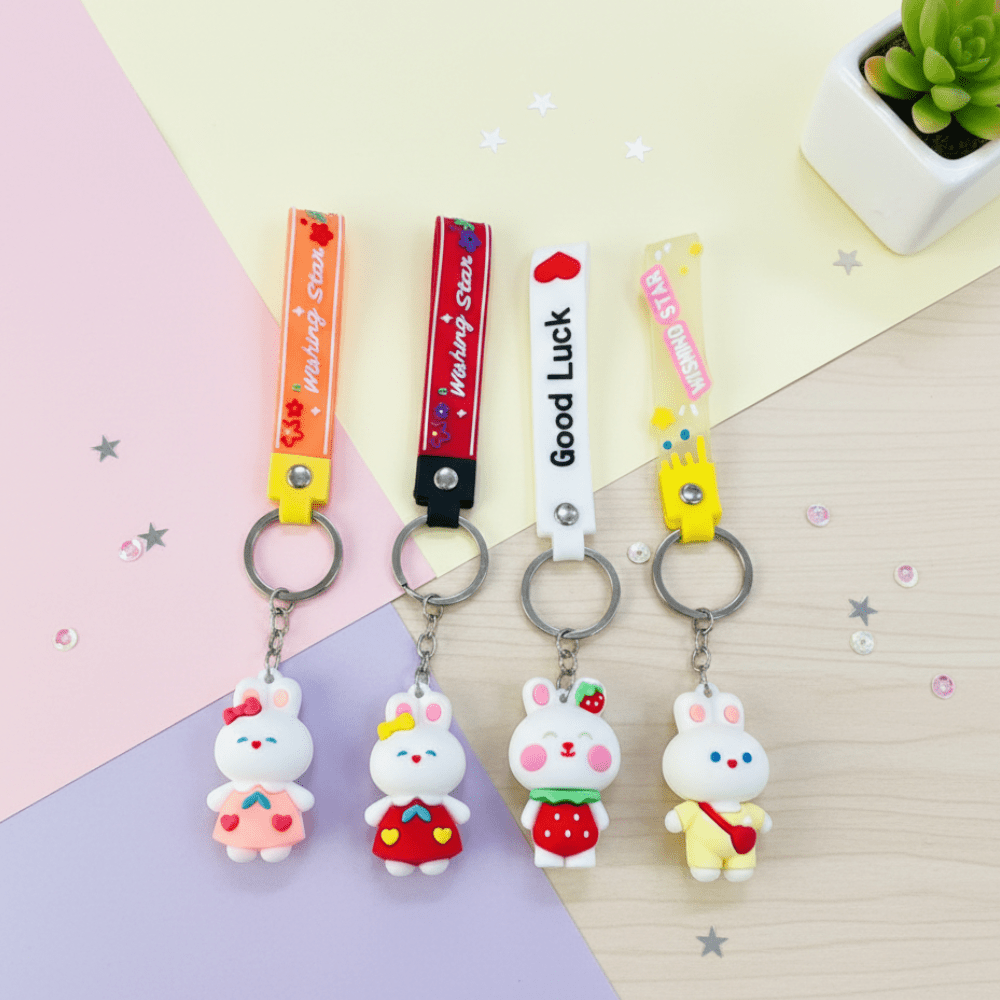Cute Bunny KeychainKeychainsCRAFTY CUDDLEFour cartoon rabbit keychains with different colored straps on a pastel background.1BunnyKeychain CuteKeyring KawaiiAccessories GirlsBagCharm CartoonKeychain KidsReturnGifts BackpackCharm RabbitKeychain TrendyKeyrings GiftForGirls