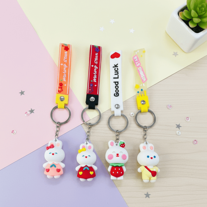 Cute Bunny KeychainKeychainsCRAFTY CUDDLEFour cartoon rabbit keychains with different colored straps on a pastel background.1BunnyKeychain CuteKeyring KawaiiAccessories GirlsBagCharm CartoonKeychain KidsReturnGifts BackpackCharm RabbitKeychain TrendyKeyrings GiftForGirls