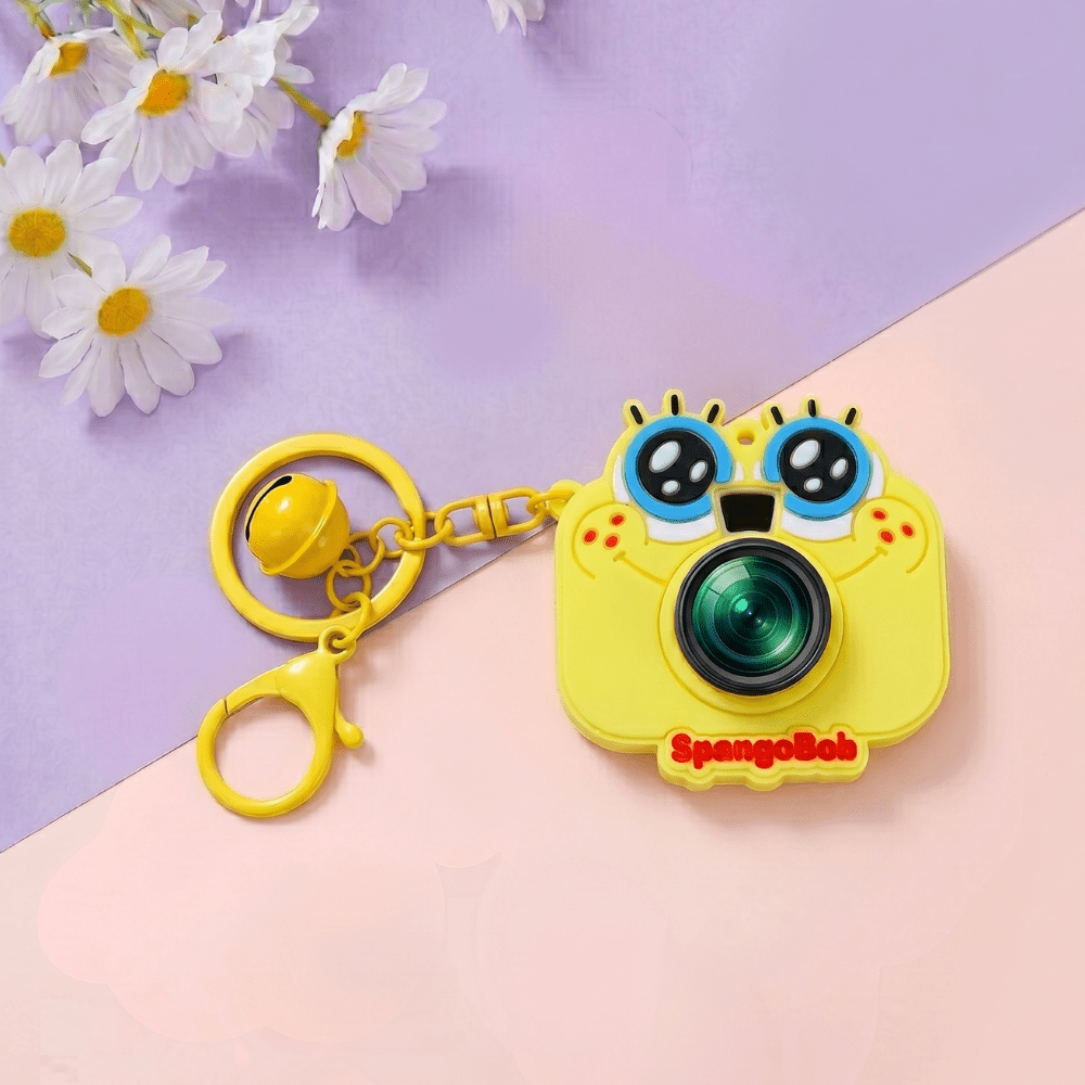 Cute Camera Shape Projector KeychainKeychainsCrafty CuddleYellow camera - shaped keychain with 'SpongeBob' branding on a pink and purple background with flowers.Light YellowCuteKeychain KawaiiAccessories KidsAccessories ReturnGiftIdeas CartoonKeychain MiniCamera BagCharm StationeryLove GiftForKids TrendingNow