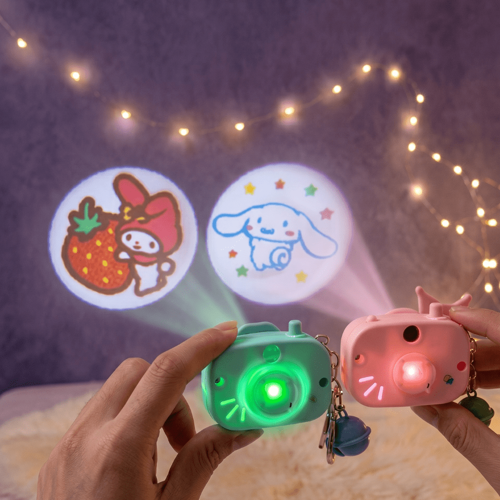 Cute Camera Shape Projector KeychainKeychainsCrafty CuddleTwo colorful projection toys being held with projected images on a dark background.Dark PinkCuteKeychain KawaiiAccessories KidsAccessories ReturnGiftIdeas CartoonKeychain MiniCamera BagCharm StationeryLove GiftForKids TrendingNow