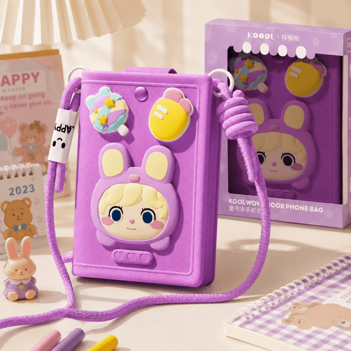 Cute Cartoon Crossbody Phone Bag for GirlsKids BagsCrafty CuddleA purple cartoon phone bag with a bunny face and colorful decorative charms, shown alongside its retail box and a matching small plush accessory on a styled tabletop.PurpleCuteCrossbodyBag PhoneBag MiniSlingBag KawaiiStyle GirlsFashion CrossbodyBag CuteAccessories FashionAccessories MobilePouch ShopifyFindsStationeryAddict