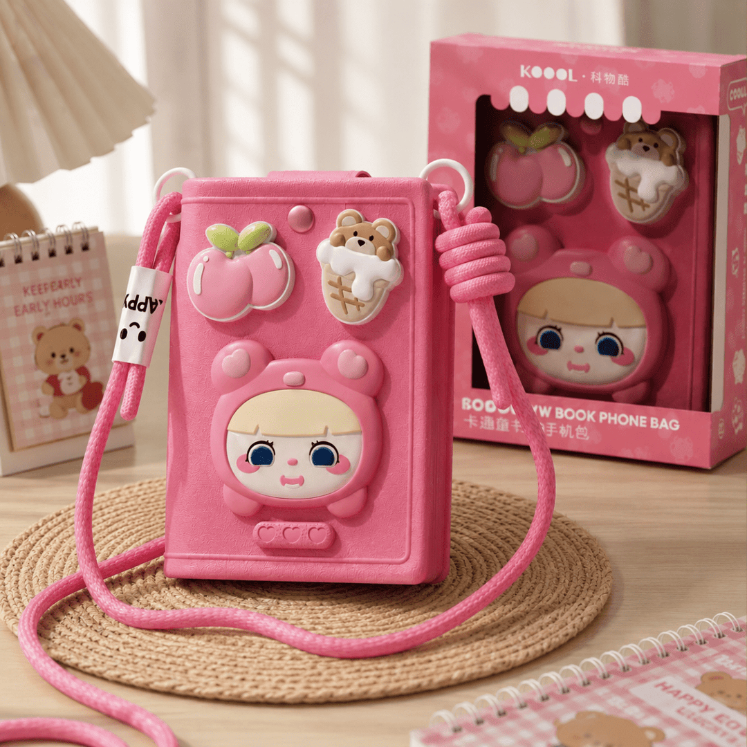 Cute Cartoon Crossbody Phone Bag for GirlsKids BagsCrafty CuddleA pink 3D-embossed book-shaped phone bag with cute cartoon character details, a pink braided shoulder strap, and decorative charms, shown next to its pink retail box on a woven mat.PinkCuteCrossbodyBag PhoneBag MiniSlingBag KawaiiStyle GirlsFashion CrossbodyBag CuteAccessories FashionAccessories MobilePouch ShopifyFindsStationeryAddict