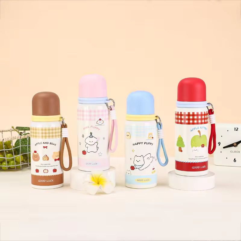 Cute Cartoon Stainless Steel Water BottleCartoon Kids Water BottleCrafty CuddleFour colorful water bottles with cartoon designs on a beige backgroundBlue