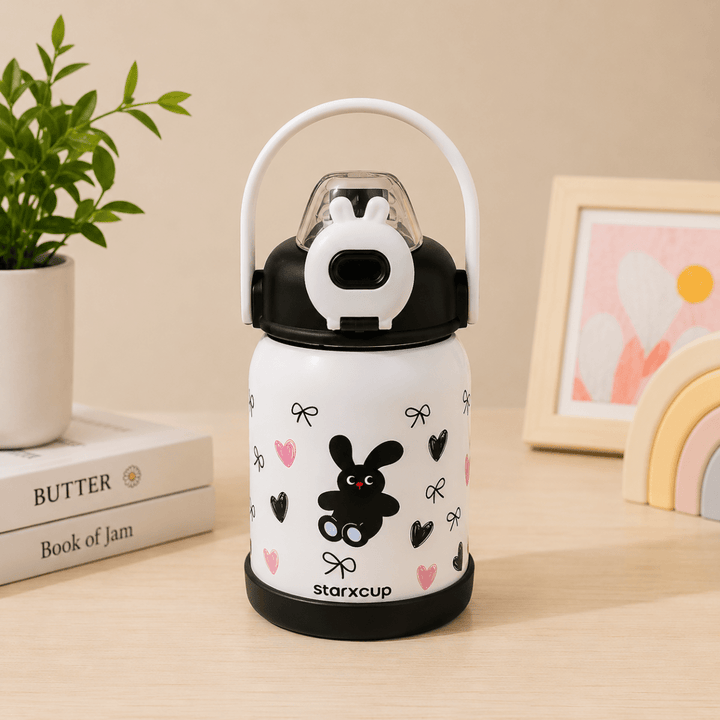 Cute Cartoon Water BottleCartoon Kids Water BottleCrafty CuddleWhite thermos with black lid and cartoon design on a wooden surface with books and a plant in the background.BlackKidsWaterBottle SchoolBottle InsulatedWaterBottle StrawBottle LeakproofBottle KidsLifestyle SchoolEssentials GiftForKids CuteKidsProducts CraftyCuddleStationeryAddict