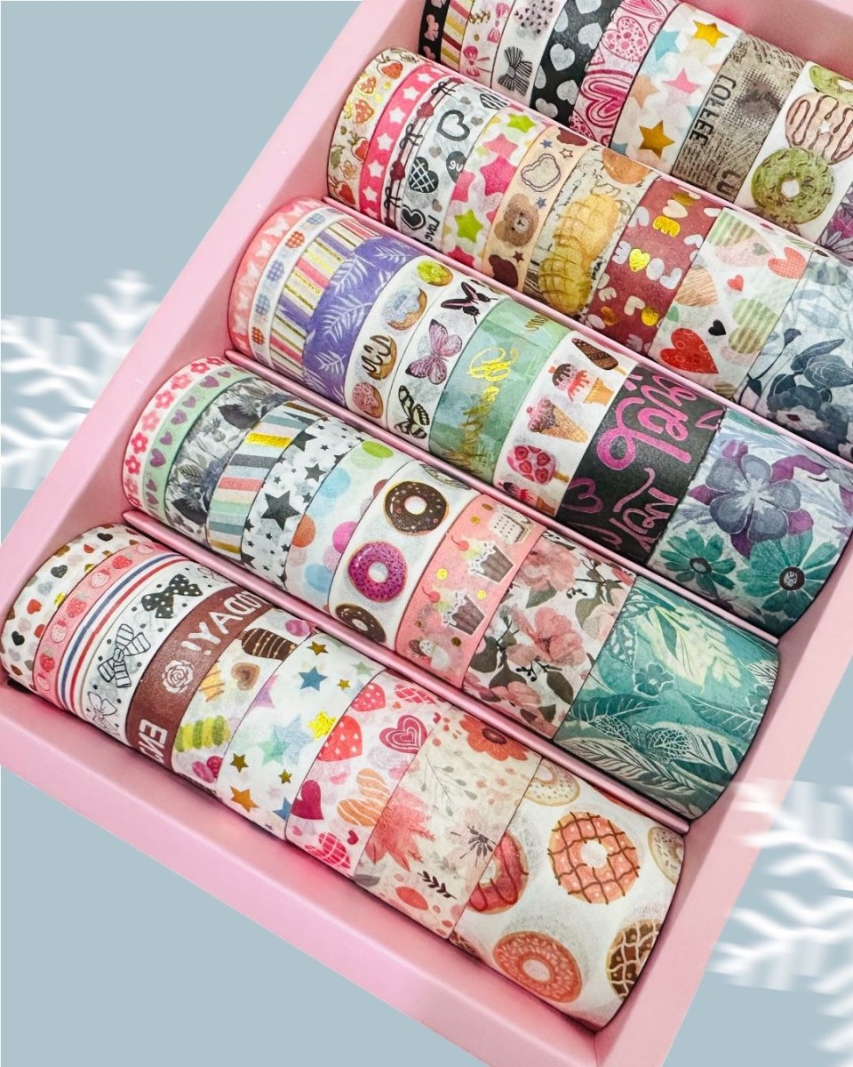 Cute Dessert &amp; Heart Theme Washi Tape Box – 50 RollsDecorative Washi TapeCRAFTY CUDDLEAssorted colorful washi tape rolls in a pink box on a light blue backgroundwashitape washitapelove washitapecollection papercrafts diycrafts journaling bulletjournal plannerdecor creativejournaling stationerylovers aestheticstationery