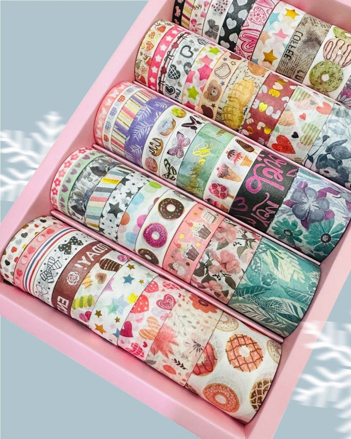 Cute Dessert &amp; Heart Theme Washi Tape Box – 50 RollsDecorative Washi TapeCRAFTY CUDDLEAssorted colorful washi tape rolls in a pink box on a light blue backgroundwashitape washitapelove washitapecollection papercrafts diycrafts journaling bulletjournal plannerdecor creativejournaling stationerylovers aestheticstationery
