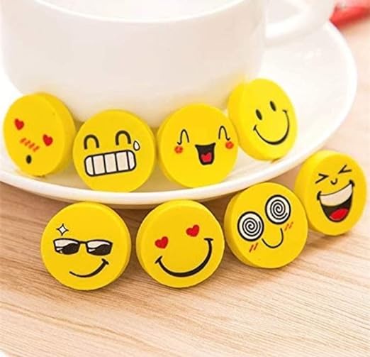 Set of yellow emoji-shaped erasers on a white plate