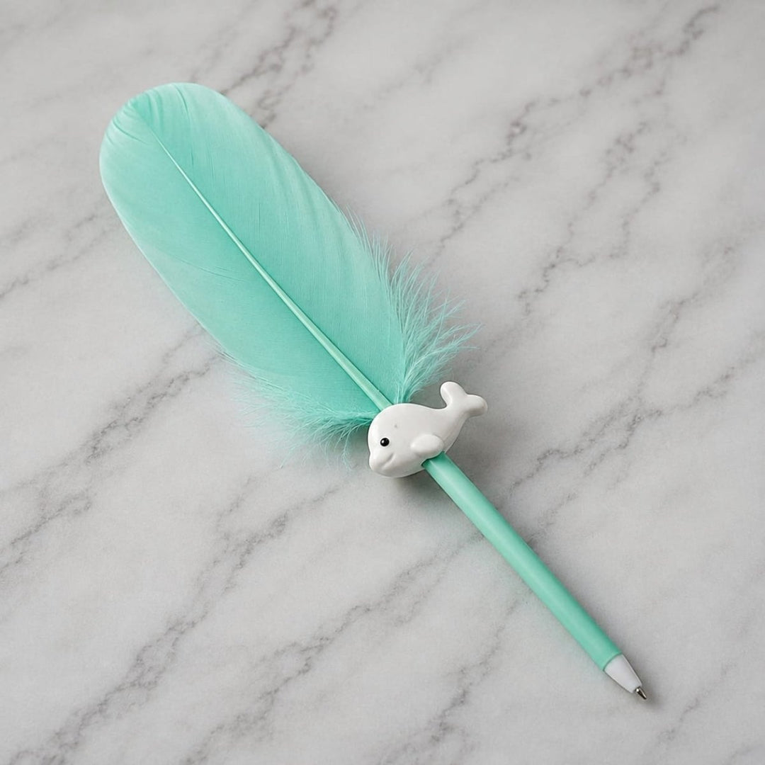 Cute Feather Ball Pen with Whale CharmFeather PenCrafty CuddleA mint green feather pen with a small white dolphin figurine on the barrel, resting on a white marble surface.greenAesthetic StationeryDecorative Pen
