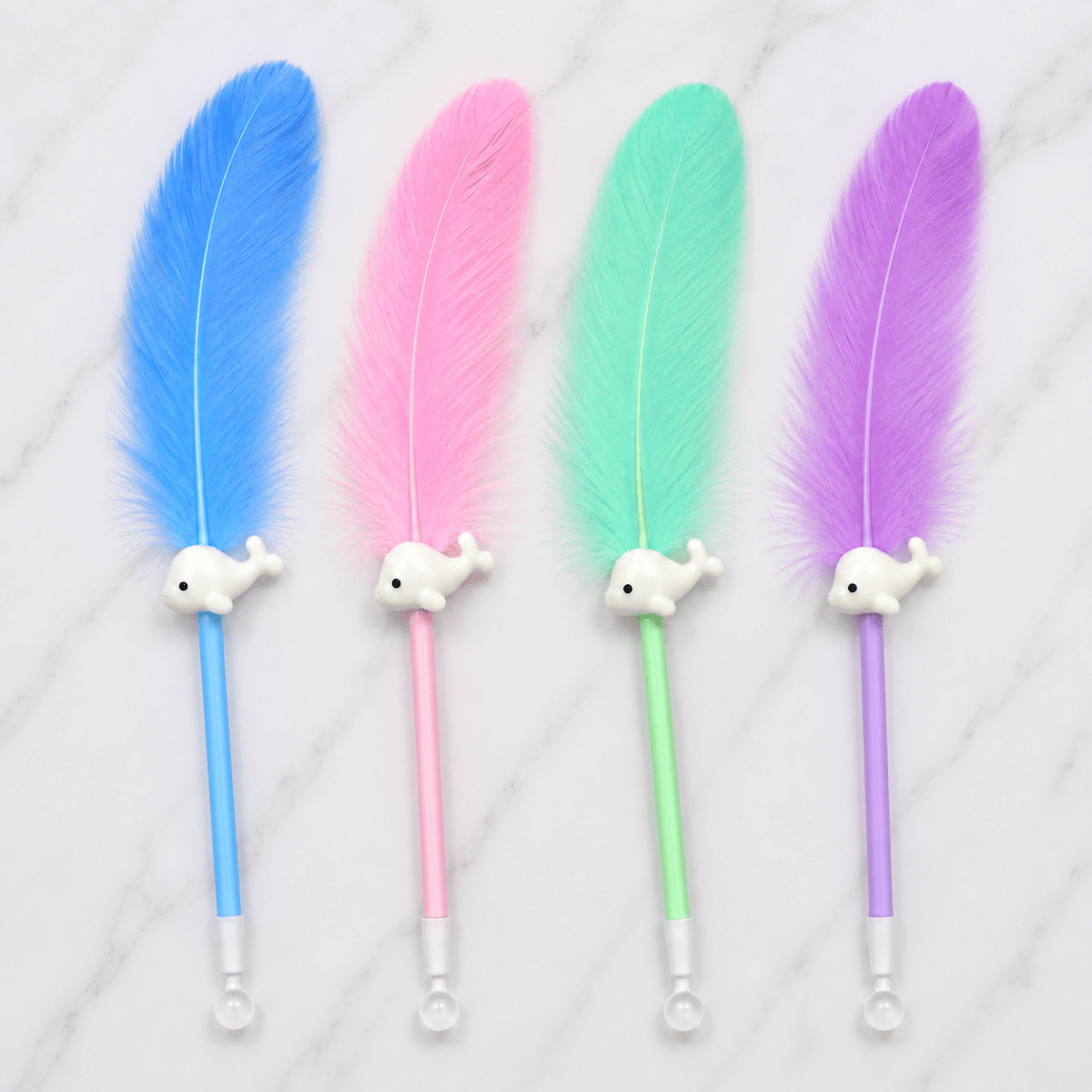 Cute Feather Ball Pen with Whale CharmFeather PenCrafty CuddleFour feather pens in blue, pink, mint green, and purple, each with a small white whale-shaped handle and a white ball at the end, arranged on a light marble surface.greenAesthetic StationeryDecorative Pen