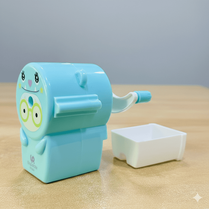 Cute Pastel Pencil Sharpener for KidsStationery > Erasers &amp; SharpenersCRAFTY CUDDLEBlue cartoon - style pencil sharpener on a wooden surface with a light gray backgroundSky Blue