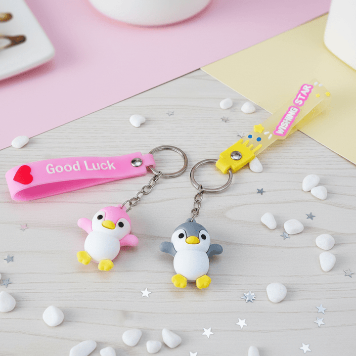 Cute Penguin KeychainKeychainsCRAFTY CUDDLETwo penguin keychains on a decorative surface with &