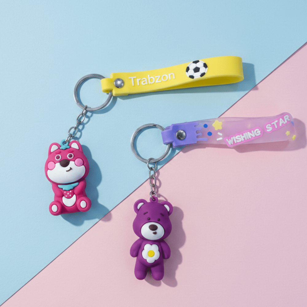 Cute Teddy Bear Silicone KeychainKeychainsCRAFTY CUDDLETwo keychains on a colorful background with &