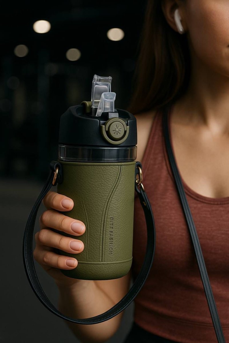 Person holding a green water bottle with a black cap
