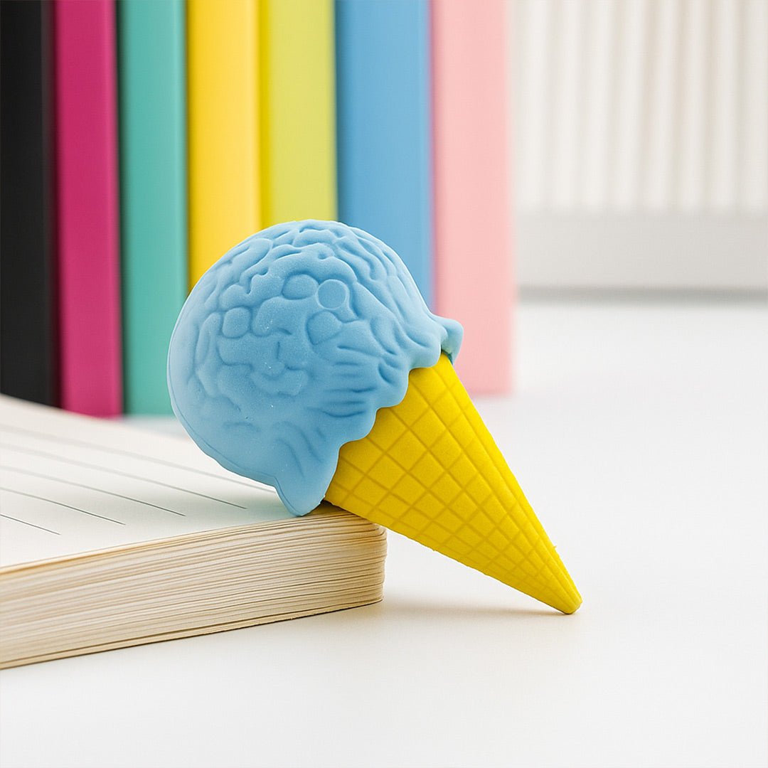 Blue ice cream cone eraser on a book with colorful books in the background