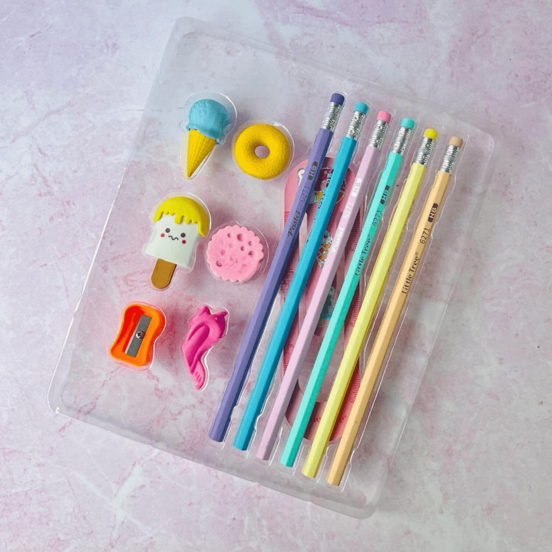 Colorful pencils and erasers on a pink background