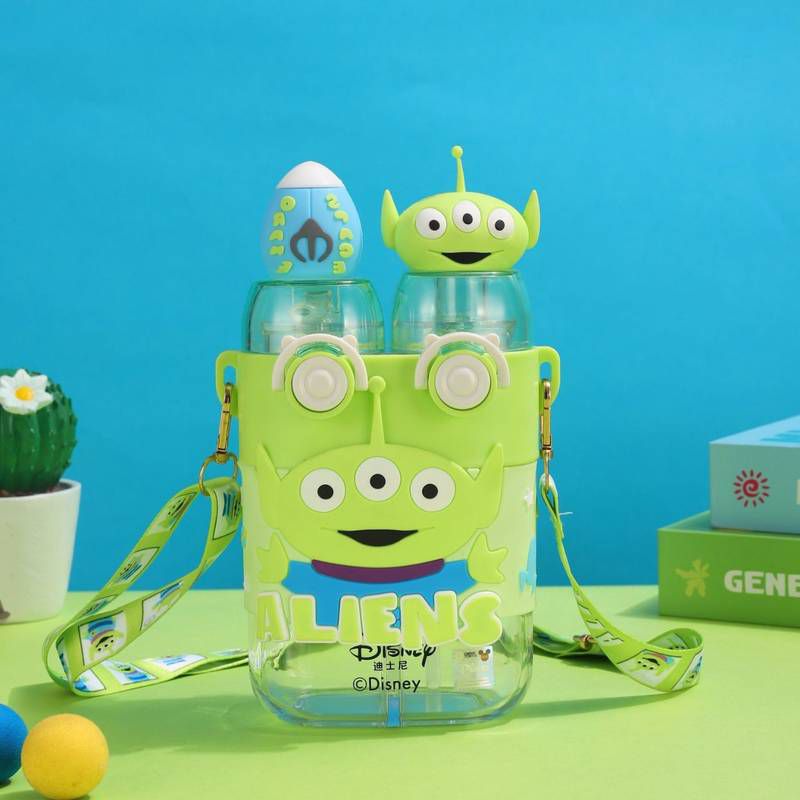 DISNEY Dual Drink Glass Water Bottle with PartitionCartoon Kids Water BottleCrafty CuddleTransparent water bottle with alien design and strap, featuring Disney branding, on a blue and green background.GreenDualCompartmentBottle 780mlBottle KidsHydration WaterBottleForKids GlassSipperBottle PortableBottle SchoolBottle CuteGiftIdeas BirthdayGiftForKids DailyHydrationStationeryAddict