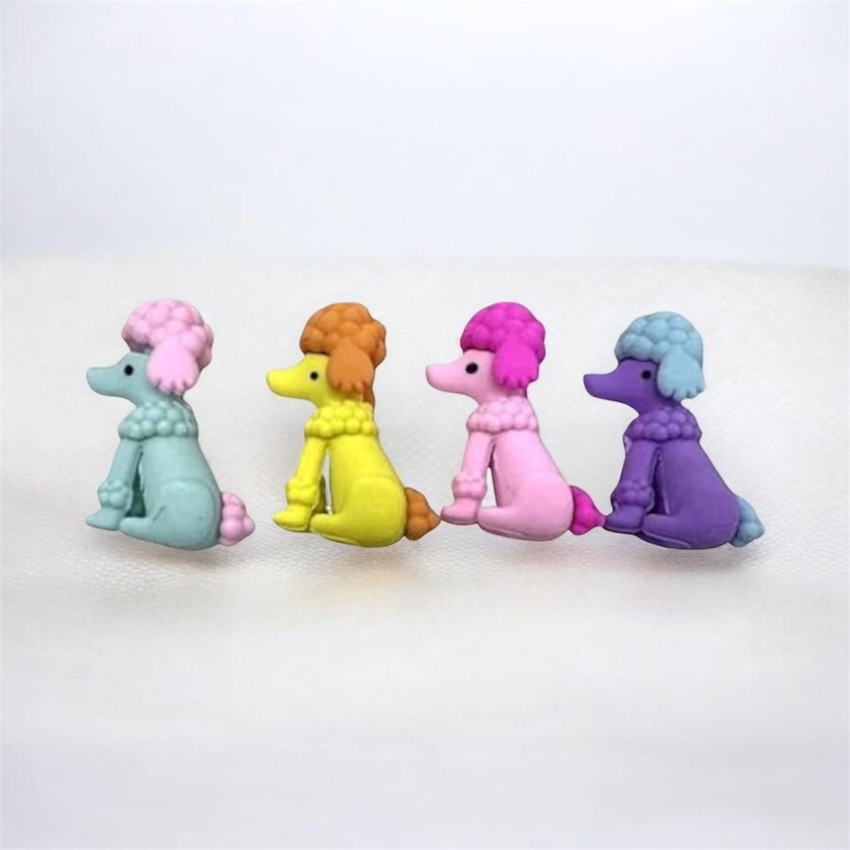 Dog ErasersErasersCRAFTY CUDDLEFour colorful poodle figurines erasers in different colors on a white background1animalerasersbacktoschoolsupplies