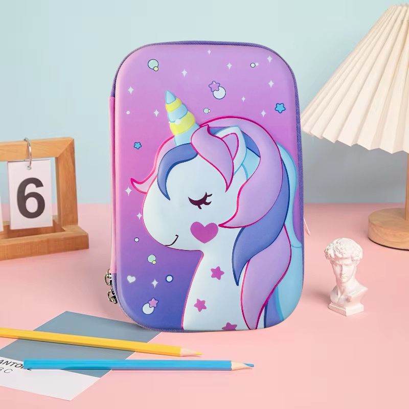 Dreamy Unicorn Pencil PouchPencil PouchCRAFTY CUDDLEPurple pencil case with a unicorn design on a pink surface with stationery items.UnicornPencilBox UnicornStationery GirlsSchoolSupplies CuteStationery EVAHardCase SchoolPencilCase CartoonPencilBox BackToSchool KidsStationery UnicornTheme StationeryLovers SchoolEssentials