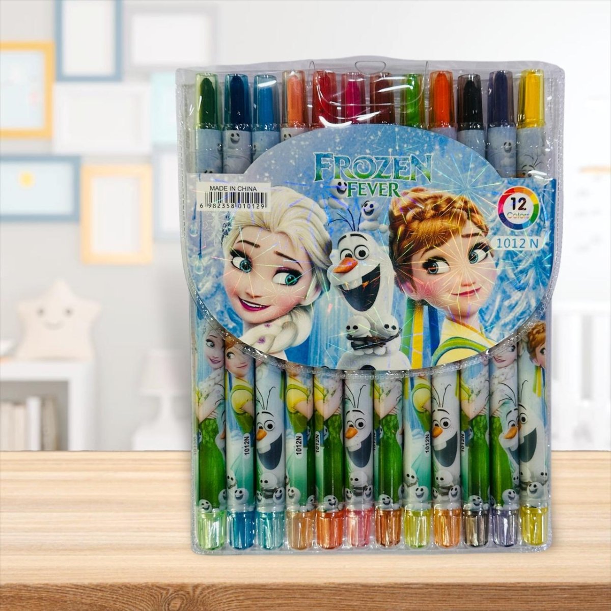 Pack of colorful crayons with Frozen Fever characters on a wooden surface.