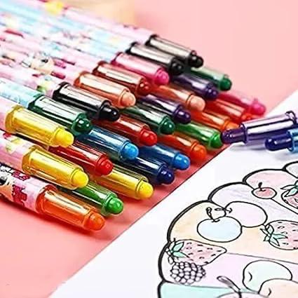Set of colorful crayons with a coloring book on a pink background